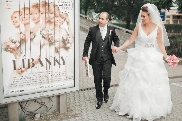 bride and groom at billboard - wedding movie