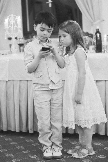 kids on wedding playing mobil phone