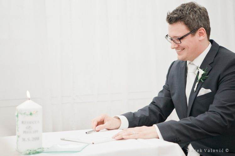 groom signing wedding contract