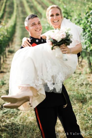 bride ang groom posing in vineyard - lifted bride