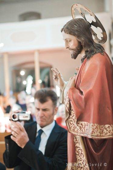 moment in the church ceremony - holy statue and man