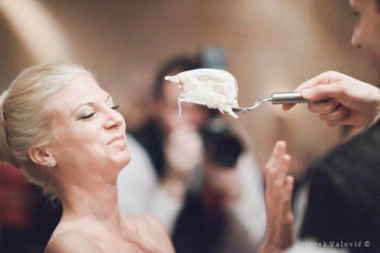 groom feeding the bride with wedding cake