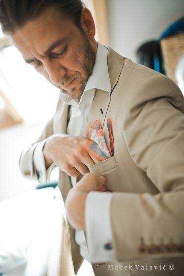 groom preparing his creamy suit