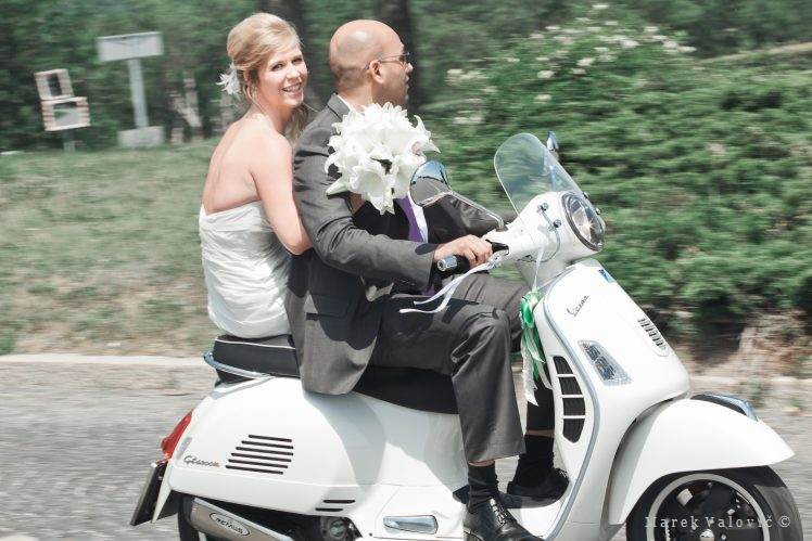 bride going to ceremony on Vespa bike